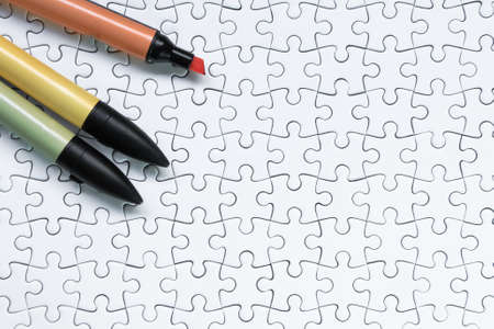 Colorful marker pen on white jigsaw puzzle background.の写真素材