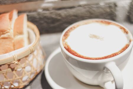 cappuccino coffee and Toast in the basket with morning light. breakfast.の写真素材