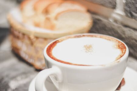 cappuccino coffee and Toast in the basket with morning light. breakfast.の写真素材