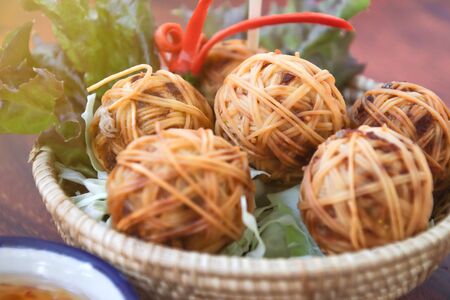 Deep Fried Wrapped Pork with Chinese Noodle or Fried pork ball with noodle or Moo Sarong with sweet chili sauce, authentic recipes, classical Thai cuisine.の写真素材