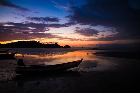 Beautiful Sky and sunset on the beach with Fishing boat silhouette.の写真素材