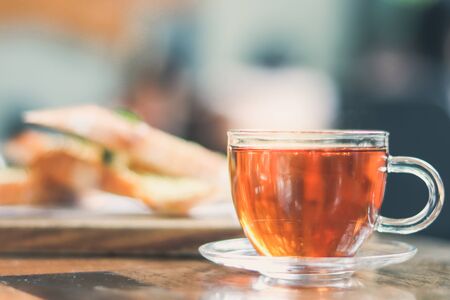 cup of tea at a cafe blurred background and garlic bread.の写真素材