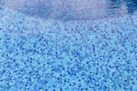 Ripple Water in swimming pool overlooking underwater tiles.の写真素材