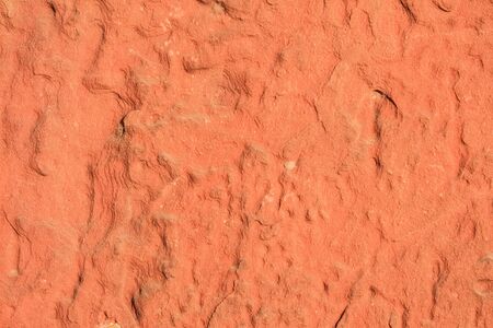 Red laterite stone surface texture background.