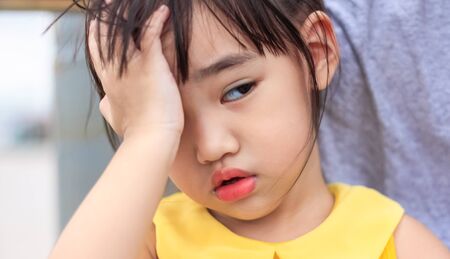 Portrait of cute Little asian girl,Children's headacheの写真素材