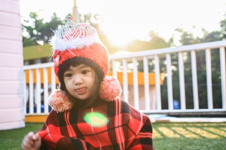 Portrait of cute Little asian girl in moment of happiness with sun rise.Children wear sweaters.の写真素材