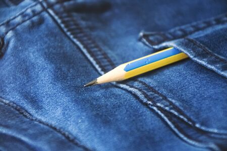 pencil in back blue jeans pocket denim background texture.
