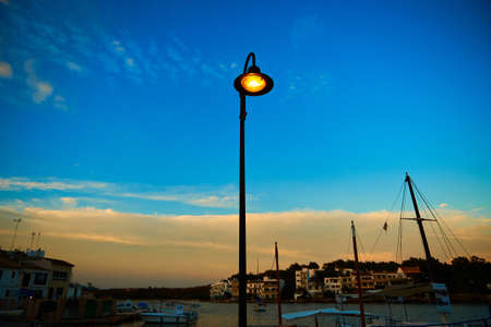 Single street lamp in a small european seaport townの写真素材