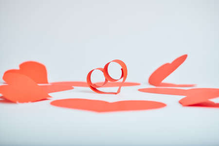 Valentine's Day theme with composition of red paper hearts for cards and backgrounds