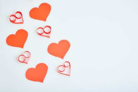 Valentine's Day theme with composition of red paper hearts for cards and backgroundsの写真素材