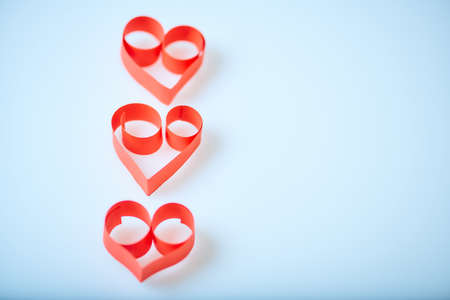 Valentine's Day theme with composition of red paper hearts for cards and backgroundsの写真素材