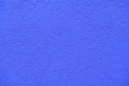 The texture of plastered deep or medium blue wall, background