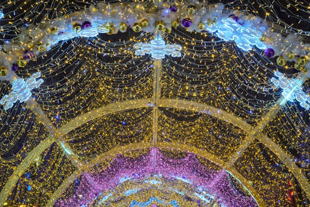 Christmas outdoor decoration arch with a lot of gold and ultraviolet lightsの写真素材