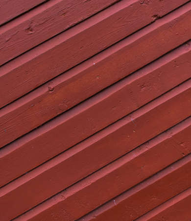 Red painted wooden planks with peeling off paint