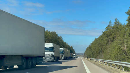 2022 04 12 Lithuania, road to the Lithuanian-Belarus border crossing   in Medininkai. Cargo truck queue - more than 12 km in length. Similar queues are in other main border crossings. Video availableのeditorial素材