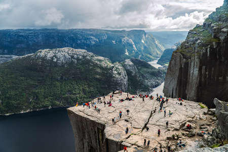 Tourists on Trolltunga, Trolltunga, Norway. Trolltunga is a popular tourist attraction.の写真素材
