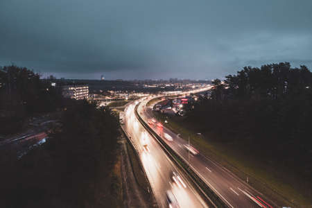 Aerial view of highway at night with cars moving on the roadの写真素材