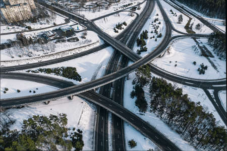 Aerial view of a highway in winter with snow in the cityの写真素材