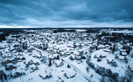 Aerial view of a small town in winter with snow covered houses.の写真素材