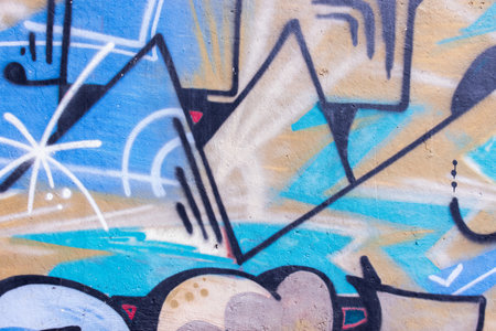 Fragment of colored graffiti painted on a wall. Abstract background for design.
