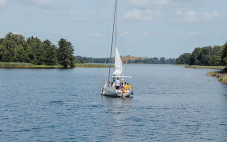 GalvÄ— lake in Trakai near Trakai Castle with a sailing tourist boat in summer