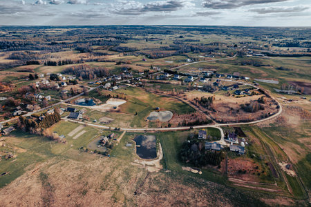 Aerial view of rural area with houses and lake in Lithuaniaの写真素材
