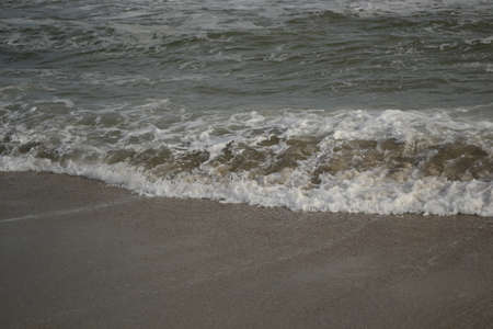 Wave of the sea on a sandy beach. High quality photo.