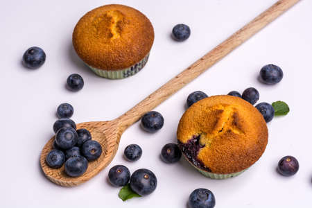 Blueberry muffins with blueberries on white backgroundの写真素材
