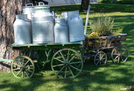 Several old milk churns on a wagon at the "Gurten" in Bern in the sunの写真素材