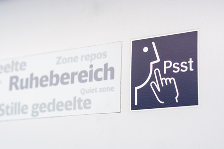 A sign and a symbol for "Quiet Zone" in a train isolatedの写真素材