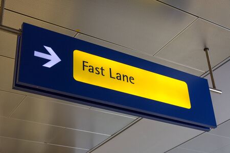 Fast Lane sign in blue and yellow at the airport close up