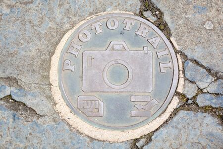 A Phototrail sign on the ground on the pavement