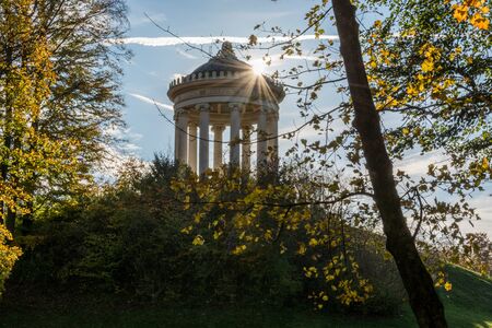 The Monopteros temple in the English Garden in Munich, Germany with sun raysの写真素材