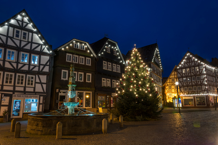 FRITZLAR, GERMANY: 25th December 2017: The marketplace of Fritzlar with fountain and Christmas tree and fairy lights during blue hourのeditorial素材