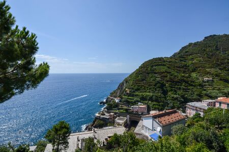 View on the sea and cliffs from Riomaggiore at Cinque Terre on a sunny day
