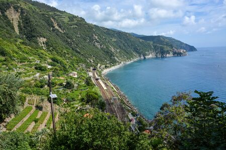 The train station of Corniglia seen from above with a view on the coastline and Manarola in the...