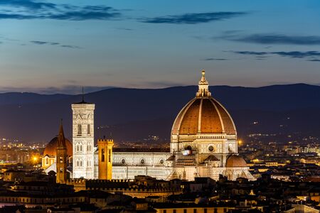 Florence with the lit cathedral Santa Maria del Fiore at nightの写真素材