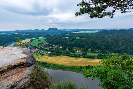 The river Elbe in Saxon Switzerland near Dresden on a cloudy dayの写真素材