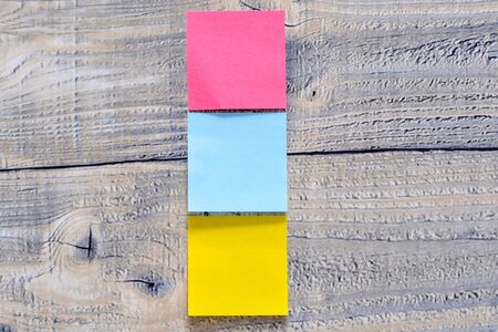 Three post its on a wooden background