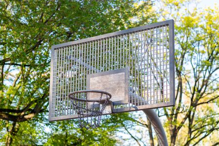A basketball hoop out of metal in a park