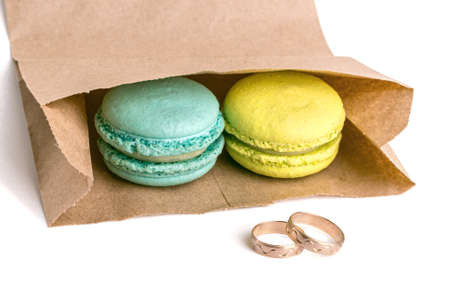 Macaron and wedding rings. Eco food packaging bagの写真素材