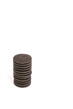 Cookie and cream chocolate cookies in stack and single pieces isolated on white background