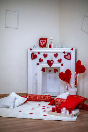 White fireplace decorated with red hearts for Valentines Dayの写真素材