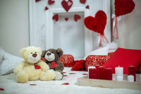 Candles in interior. Valentines day concept bears couple in love.Couple cute Teddy Bears loving, date.の写真素材