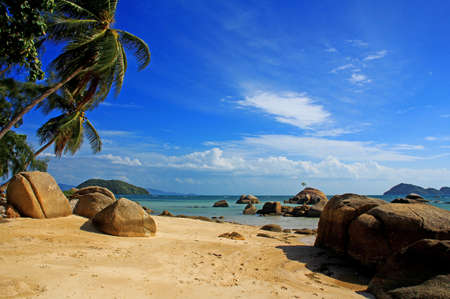 Sunny beach, cloud on the blue sky and stonesの写真素材