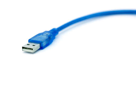 The blue USB cable lies on a white backgroundの写真素材