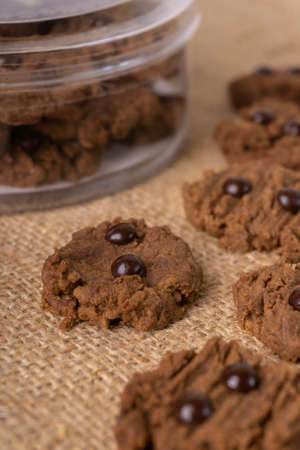 Chocolate chip cookies on burlap background. Selective focus.