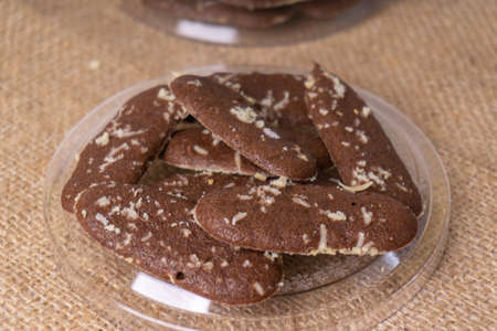 chocolate cookies on a glass plate on a burlap background.の写真素材