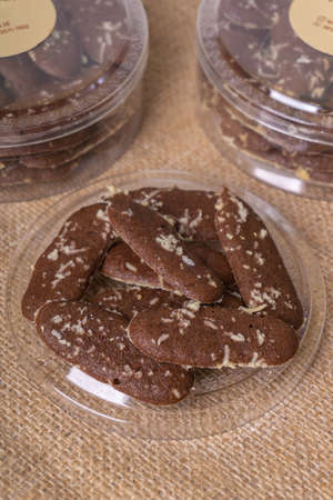 Homemade chocolate cookies in a glass jar on burlap background.の写真素材