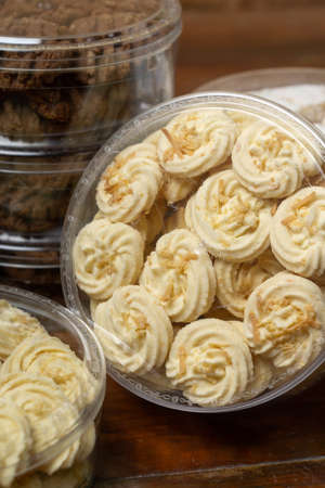 cookies in a plastic container on a wooden table, close-upの写真素材